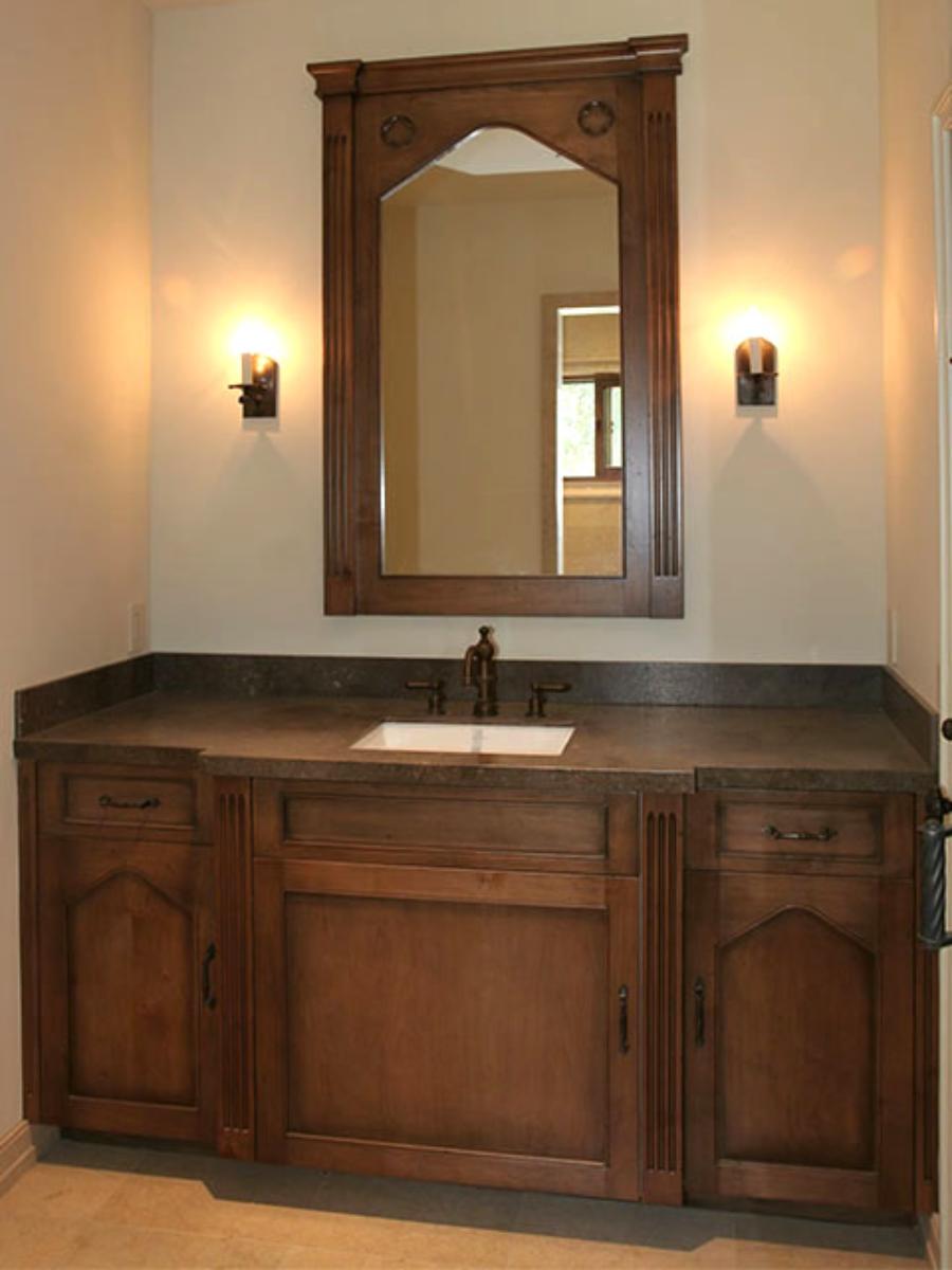 Stained wood vanity with custom mirror frame and stone top, Santa Ynez project